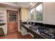 Galley kitchen with granite countertops, stainless steel sink, and gas range, offering functionality and style at 2343 Wilshire Dr, Dunedin, FL 34698