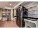 Functional kitchen featuring stainless steel appliances, open shelving, and butcher block countertops at 2343 Wilshire Dr, Dunedin, FL 34698