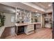 Spacious living area featuring hardwood floors and built-in shelving and adjacent dining space at 2343 Wilshire Dr, Dunedin, FL 34698