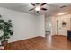 Bright living room featuring wood-look floors, ceiling fan, and neutral paint at 2343 Wilshire Dr, Dunedin, FL 34698