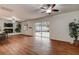 Living room with fireplace, sliding glass doors to patio, and wood-look floors at 2343 Wilshire Dr, Dunedin, FL 34698