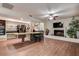 Spacious living room with hardwood floors, white brick fireplace, and built-in shelving at 2343 Wilshire Dr, Dunedin, FL 34698