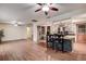 Open-concept living room with wood floors, ceiling fans, and a bar seating area, perfect for entertaining at 2343 Wilshire Dr, Dunedin, FL 34698