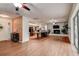 Spacious open-concept living room with wood floors, fireplace, and view of the kitchen at 2343 Wilshire Dr, Dunedin, FL 34698