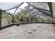 Enclosed patio area with natural light, stone flooring, and an outdoor table and chairs at 2343 Wilshire Dr, Dunedin, FL 34698