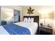 Comfortable bedroom features a bed, closet, and wooden furniture at 2506 N Rocky Point Dr # 242, Tampa, FL 33607