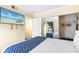 Bedroom featuring beach-themed decor, bed, and closet at 2506 N Rocky Point Dr # 242, Tampa, FL 33607
