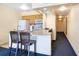 Compact kitchen features white appliances and a breakfast bar with two stools at 2506 N Rocky Point Dr # 242, Tampa, FL 33607