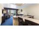 Living area with TV, chair, and breakfast bar, adjacent to balcony access at 2506 N Rocky Point Dr # 242, Tampa, FL 33607