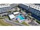 Aerial view of a community pool with lounge chairs surrounded by well-maintained landscaping and condo buildings at 2506 N Rocky Point Dr # 242, Tampa, FL 33607