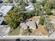 A home with a driveway, small shed, and mature trees, close to the street at 2606 N Boulevard, Tampa, FL 33602