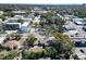 Aerial view showcasing property among trees, and nearby gas station and retail buildings in the community at 2606 N Boulevard, Tampa, FL 33602