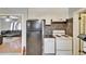 Efficient kitchen area with standard appliances, a black fridge, and view to the living room at 2606 N Boulevard, Tampa, FL 33602