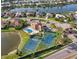 Stunning aerial view of the community pool, tennis courts, and waterway homes at 2769 Harvest Drive, Sarasota, FL 34240