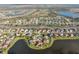 Aerial view of a lakeside community with well-maintained homes and landscaping at 2769 Harvest Drive, Sarasota, FL 34240