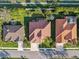 Aerial view of homes with red tile roofs, well-manicured lawns, and paved driveways at 2769 Harvest Drive, Sarasota, FL 34240