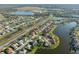 Aerial view of a residential area with lakes and green spaces and tile roofs at 2769 Harvest Drive, Sarasota, FL 34240