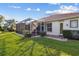Home exterior with a screened-in patio, lush lawn and landscaped garden at 2769 Harvest Drive, Sarasota, FL 34240