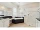 Luxury bathroom featuring a garden tub, a walk-in shower, dual windows and vanity at 2769 Harvest Drive, Sarasota, FL 34240