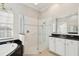 Elegant bathroom with tile shower, black granite countertop, bathtub, and a modern design at 2769 Harvest Drive, Sarasota, FL 34240