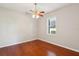 Bedroom featuring hardwood flooring, a ceiling fan, crown molding and a bright window at 2769 Harvest Drive, Sarasota, FL 34240