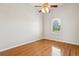 Vaulted ceiling bedroom with hardwood flooring, crown molding, a ceiling fan and a large window at 2769 Harvest Drive, Sarasota, FL 34240