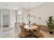 Charming dining room with an elegant chandelier and stylish wicker chairs at 2769 Harvest Drive, Sarasota, FL 34240