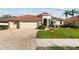 Charming single Gathering home featuring a well-manicured lawn and a three-car garage at 2769 Harvest Drive, Sarasota, FL 34240