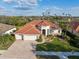 Elegant single-Gathering home with a three-car garage, manicured lawn, and paver driveway at 2769 Harvest Drive, Sarasota, FL 34240