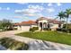 Charming single-Gathering home with lush landscaping, a paver driveway and a three-car garage at 2769 Harvest Drive, Sarasota, FL 34240