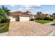 Well-maintained three-car garage with a lush, landscaped yard at 2769 Harvest Drive, Sarasota, FL 34240