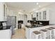 Bright kitchen featuring stainless steel appliances, granite countertops, and breakfast bar at 2769 Harvest Drive, Sarasota, FL 34240