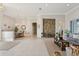 Open-concept living area with decorative accents, a stone wall, and dining area at 2769 Harvest Drive, Sarasota, FL 34240