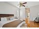 Comfortable main bedroom featuring hardwood floors, ceiling fan, and en suite bathroom at 2769 Harvest Drive, Sarasota, FL 34240