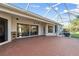 Large screened-in patio with brick flooring and a view of the backyard at 2769 Harvest Drive, Sarasota, FL 34240