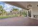 Spacious screened-in patio with brick flooring, ceiling fan, and outdoor fireplace at 2769 Harvest Drive, Sarasota, FL 34240