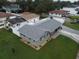 Aerial view of a home with a gray roof, blue shutters, and newly placed brick pavers at 302 N Lauber Way, Tampa, FL 33609