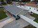 Aerial view of the home showing new roof, long brick paver driveway, and fenced backyard at 302 N Lauber Way, Tampa, FL 33609