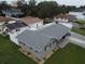 Aerial view of a gray home with well-maintained landscaping and a new roof at 302 N Lauber Way, Tampa, FL 33609