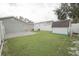 Fenced backyard featuring a patio, grass, and a storage shed at 302 N Lauber Way, Tampa, FL 33609