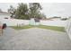 Large backyard featuring a storage shed, grassy area, white fence and patio at 302 N Lauber Way, Tampa, FL 33609