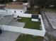 Aerial view of fenced backyard featuring a patio, grass, and a storage shed at 302 N Lauber Way, Tampa, FL 33609