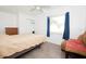 Bedroom features a ceiling fan, window with blue curtains and neutral walls at 302 N Lauber Way, Tampa, FL 33609