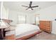 Bright bedroom with a ceiling fan, closet with sliding doors, and natural light from two windows at 302 N Lauber Way, Tampa, FL 33609