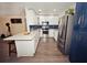 Modern kitchen featuring white cabinets, a white countertop island, and stainless steel appliances at 302 N Lauber Way, Tampa, FL 33609