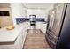 Bright kitchen features stainless steel appliances, white cabinets, and beautiful countertops at 302 N Lauber Way, Tampa, FL 33609