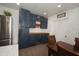 Kitchen with stainless steel appliances, a dining area and navy blue cabinets, creating a stylish and functional space at 302 N Lauber Way, Tampa, FL 33609