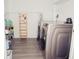 Well-lit laundry room with modern washer and dryer, and ample storage for supplies at 302 N Lauber Way, Tampa, FL 33609