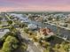 Beautiful home with a tile roof and a canal in a waterfront community from an aerial perspective at 3447 Flamingo Blvd, Hernando Beach, FL 34607