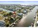 Stunning aerial view of a waterfront community with lush landscaping and canal access to the open bay and Gulf of Mexico at 3447 Flamingo Blvd, Hernando Beach, FL 34607